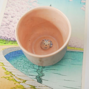 Pink porcelain cup with a blue tiger