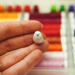 Long-tiled tit with a lace pendant
