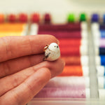 Long-tiled tit with a lace pendant