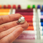 Long-tiled tit with a lace pendant