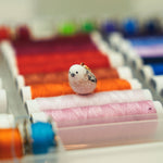 Long-tiled tit with a lace pendant