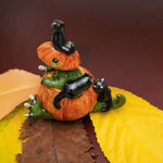 T-rex in a pumpkin with black cats figurine