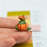 T-rex in a pumpkin pendant