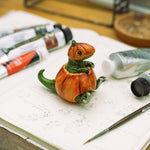 T-rex in a pumpkin figurine