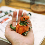 T-rex in a pumpkin figurine