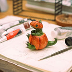 T-rex in a pumpkin figurine