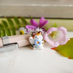 Maneki neko calico with a flower pendant