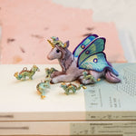 Unicorn with little dragons figurine