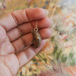 Weasel with a fern pendant