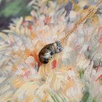 Weasel with a fern pendant