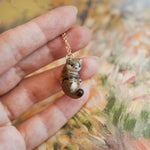 Weasel with a fern pendant