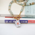 Maneki neko white with a flower pendant