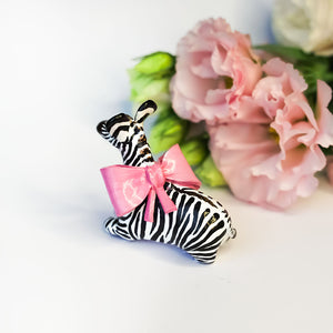 Zebra with a pink bow