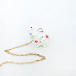 Diplodocus with colorful flowers pendant