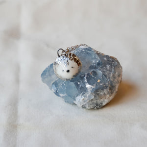 Porcelain lion with sun pendant