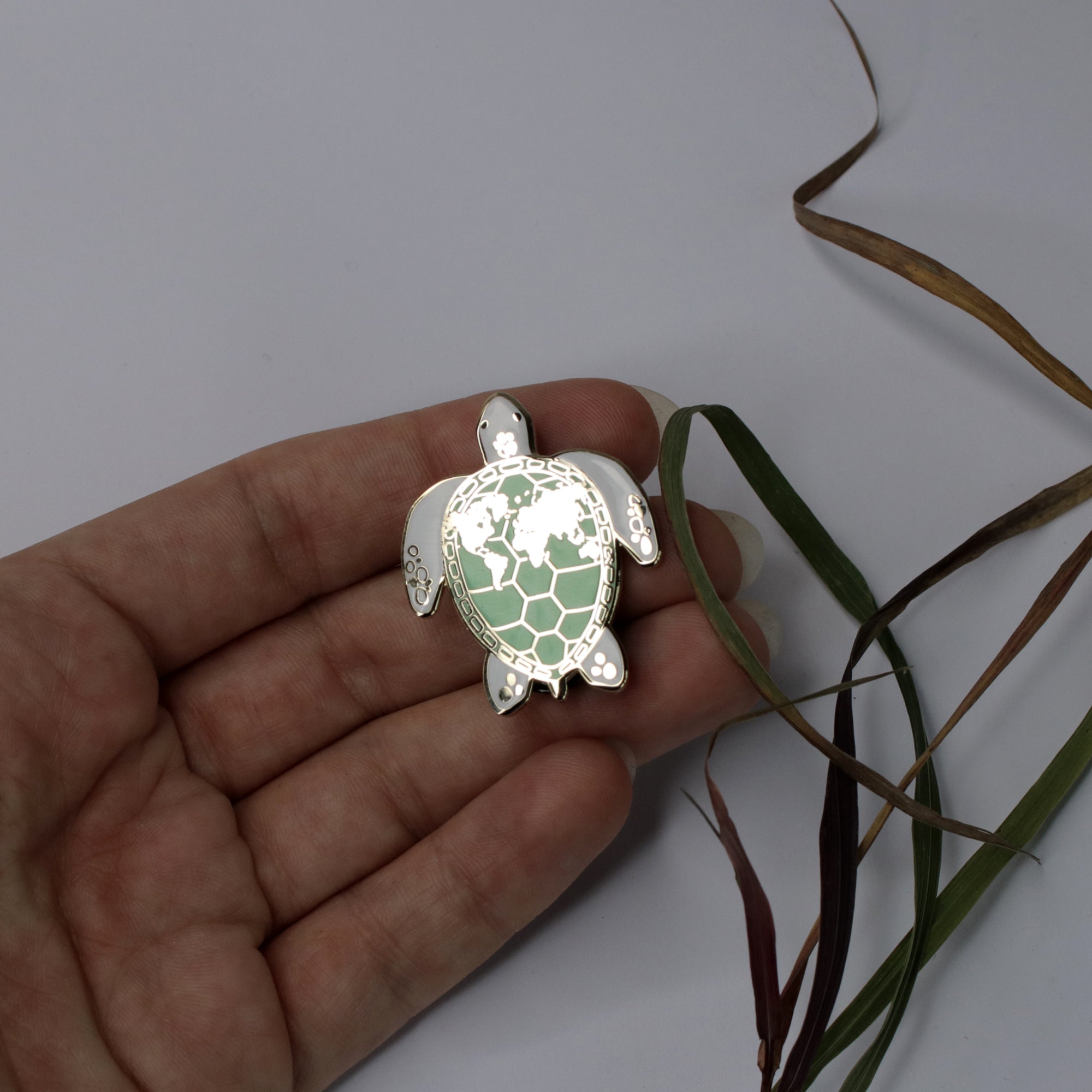 Enamel pin sea turtle with world map
