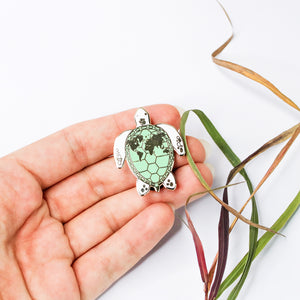 Enamel pin sea turtle with world map